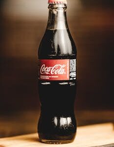 Close-up of a chilled Coca-Cola glass bottle, perfect for refreshing moments.